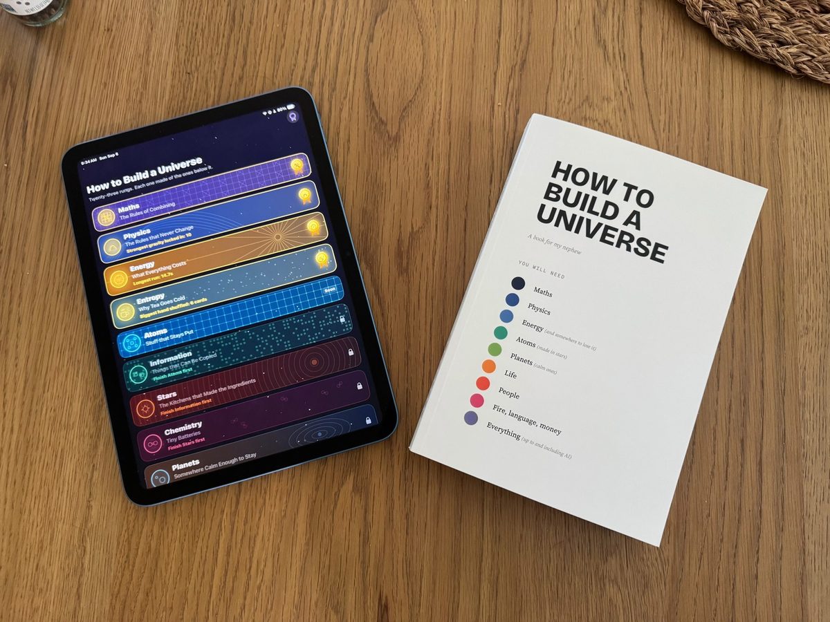 How to Build a Universe, printed, next to the companion app on an iPad